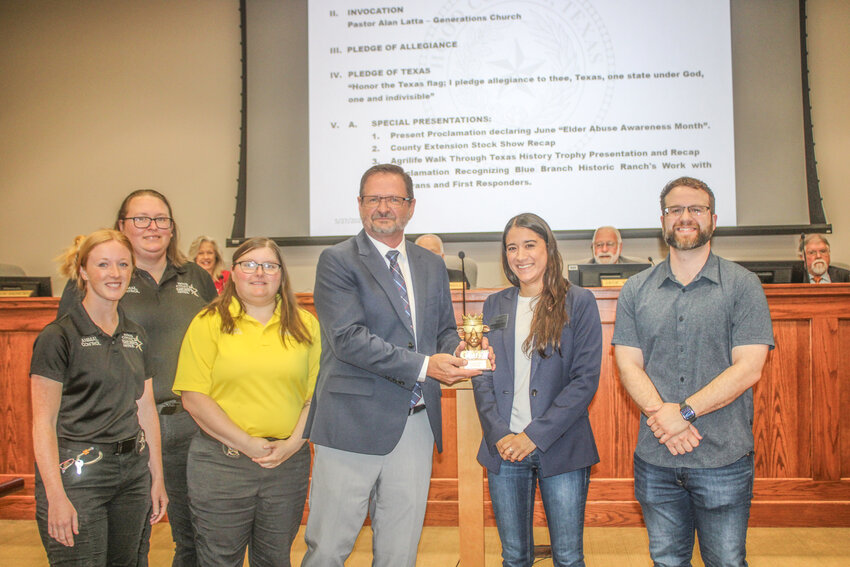Precinct 1 Commissioner Kevin Andrews shows off his GOAT (Greatest Of All Time) trophy after his team, Caffeinated Squirrels, was crowned the winner of the Walk Through Texas History challenge.
