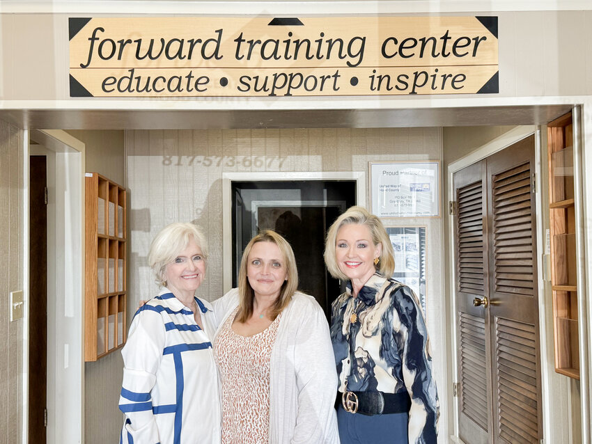 FTC Program Director Laurie Lilly, left, and Executive Director Monica Hays, right, stand proud with their new staff member — and former student — Tiffany Moffett, middle.