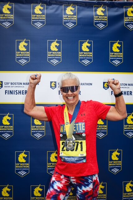 Nannette Samuelson proudly poses after she crossed the finish line at the Boston Marathon in April.