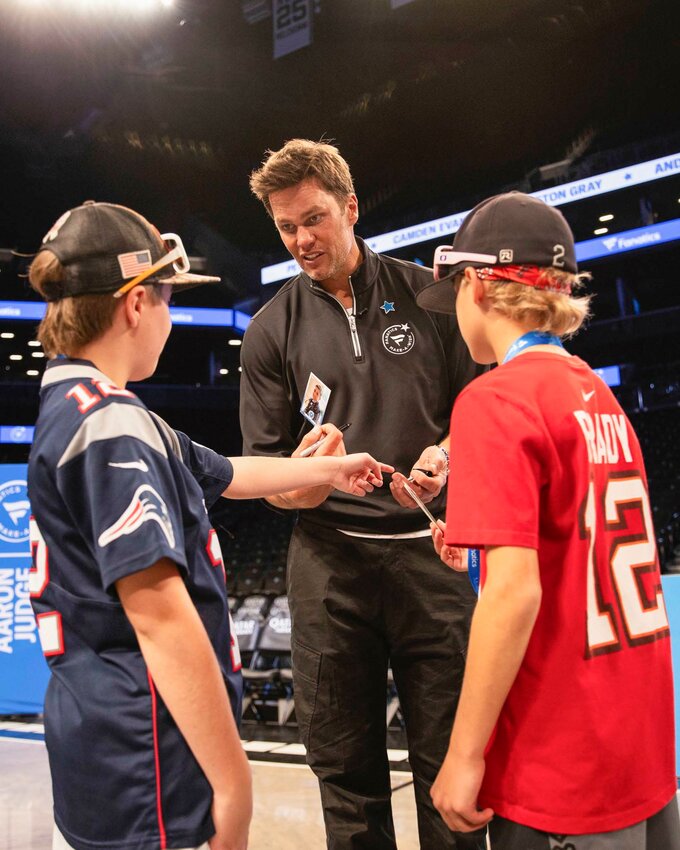 Jax and Jace Madrigal discuss trading cards with Tom Brady.