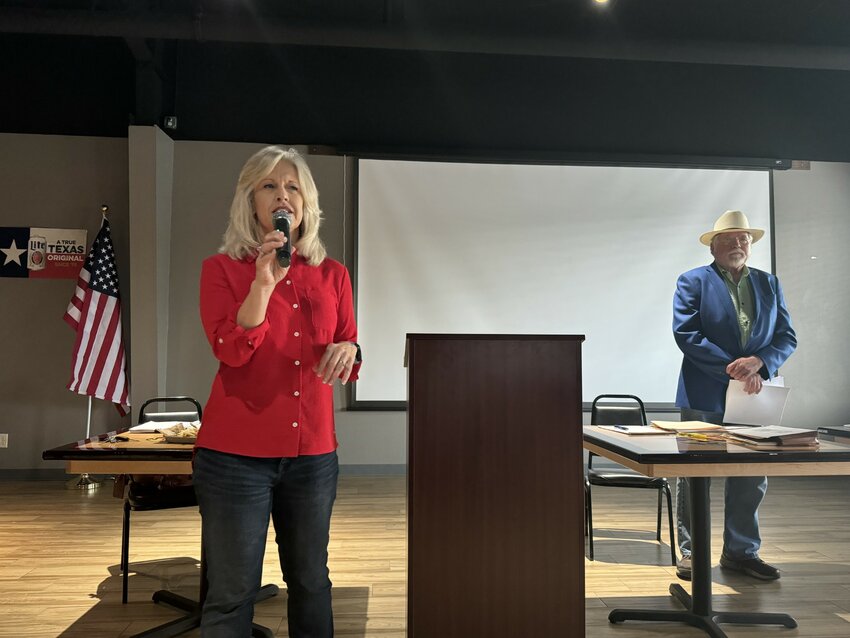 Precinct 2 Commissioner Nannette Samuelson and Precinct 4 Commissioner Dave Eagle speak to the public during a Community Town Hall meeting at Wings Etc. May 16.