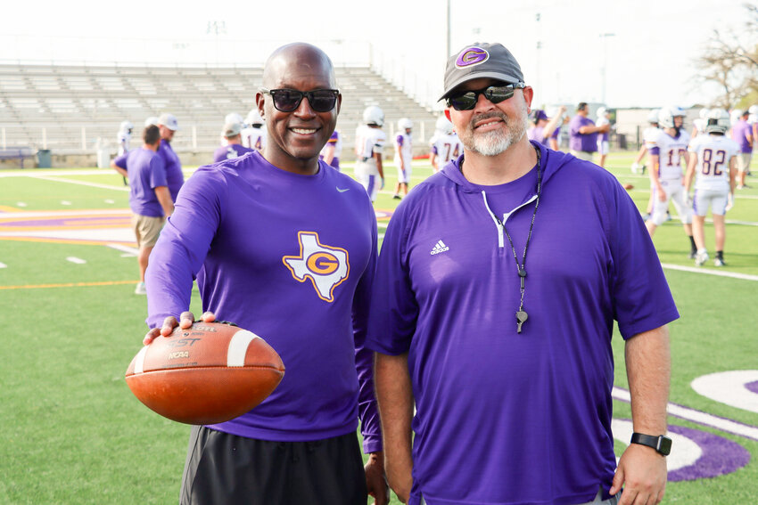 Granbury's new athletic director Lamont Moore (left) and new head football coach Bobby Allison visit during spring workouts.