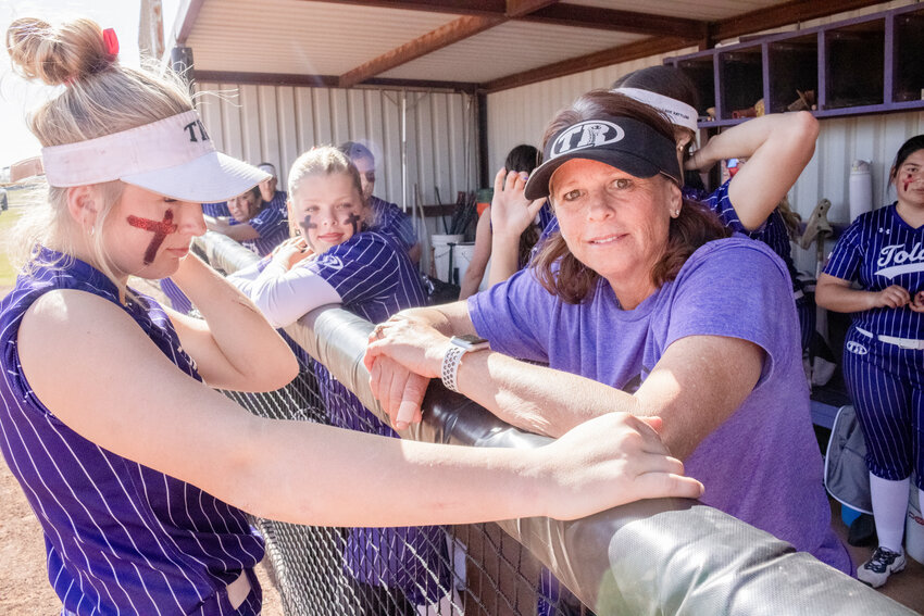 Christy Collie before a game March 21, in the dugout talking with her players.