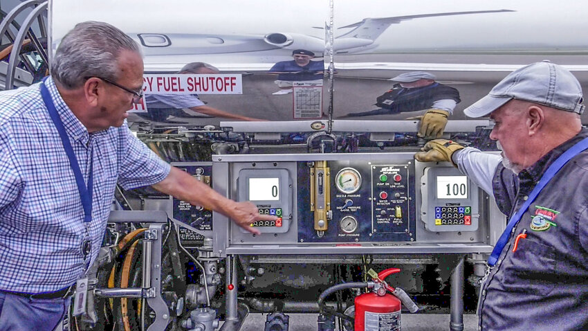 Gary Cozart, Airport Supervisor, and Mike Roney, Airport Attendant, begin refueling a large jet at the Granbury Regional Airport.