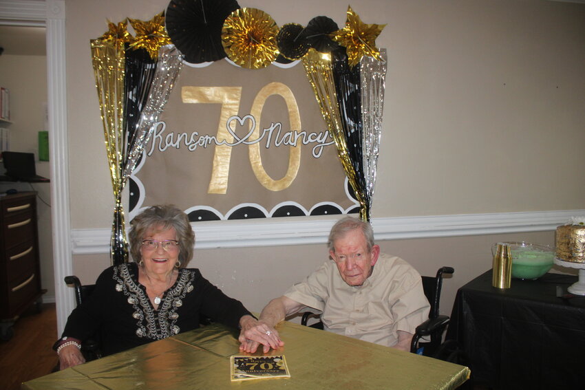 AVIVA Granbury residents Nancy and Ransom (Ranny) Danley hold hands at their party May 28, as they celebrate their 70th wedding anniversary.