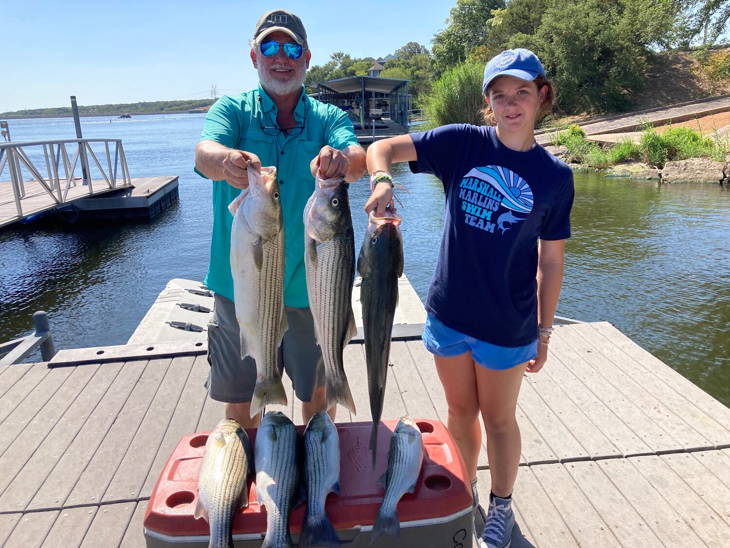 Pictured is Patrick Ryan and his daughter Bridget with their catch of big Granbury striped bass caught this last weekend.
