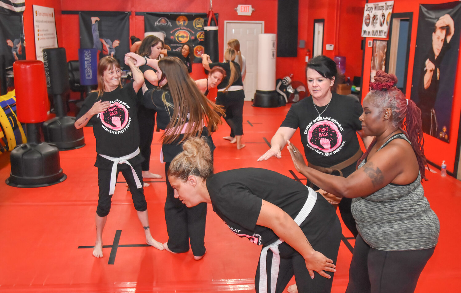 Glenda Williams, second from right, instructs two participants in a Wednesday night women’s self-defense class. Glenda and her husband Danny own and operate the Danny Williams Combat Martial Arts Program on West Pearl Street.