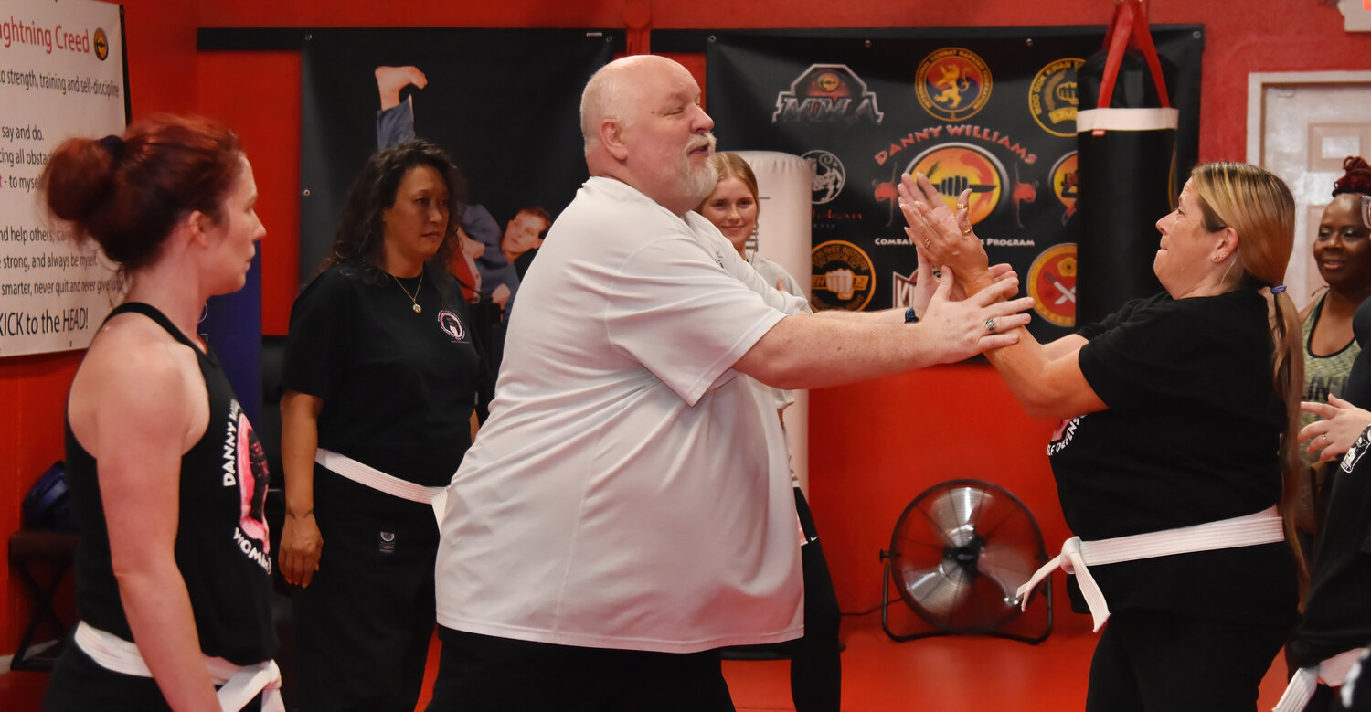 Danny Williams instructs a student at his self-defense class for women on Wednesday, May 24. The former Marine began learning martial arts at age four.