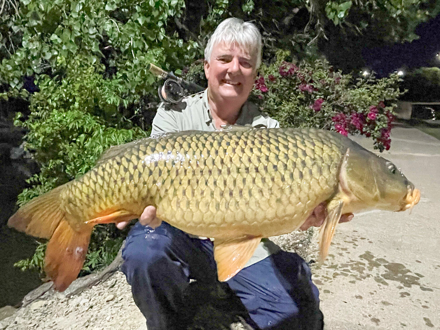 Barry Osborn holds his latest record fishing catch, a 26.1-pound, 35.25-inch common carp he caught in Lake Granbury.