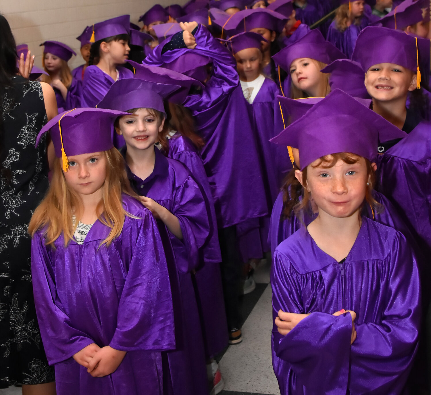 Eighty kindergarteners at Oak Woods School wait patiently in excited anticipation of their graduation ceremony on May 19.