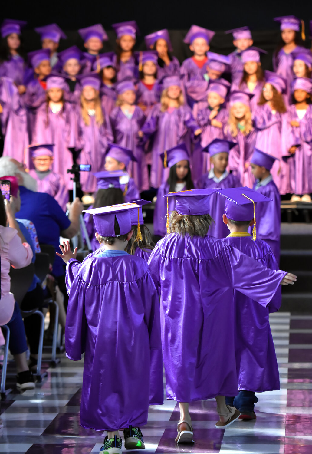All 69 kindergarten students at Nettie Baccus Elementary School make their way to the stage for the annual graduation ceremony on May 23.