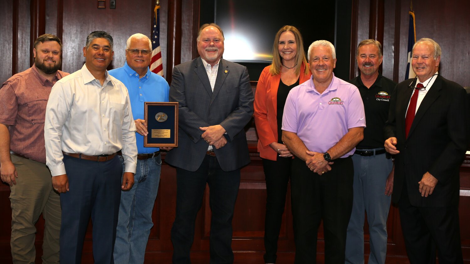 Members of the Granbury City Council joined City Manager Chris Coffman, center, Aviation Director Pat Stewart, third from left, and Deputy City Manager Michael Ross, third from right, in celebrating the award bestowed upon Granbury Regional Airport.