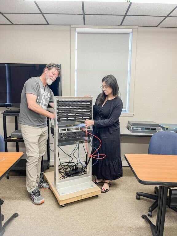 Volunteer instructor John Schlueter works with Forward Training Center student Caroline Naylor as she gains hands-on experience as part of the Cisco Network Academy. COURTESY: KATY OFFUTT