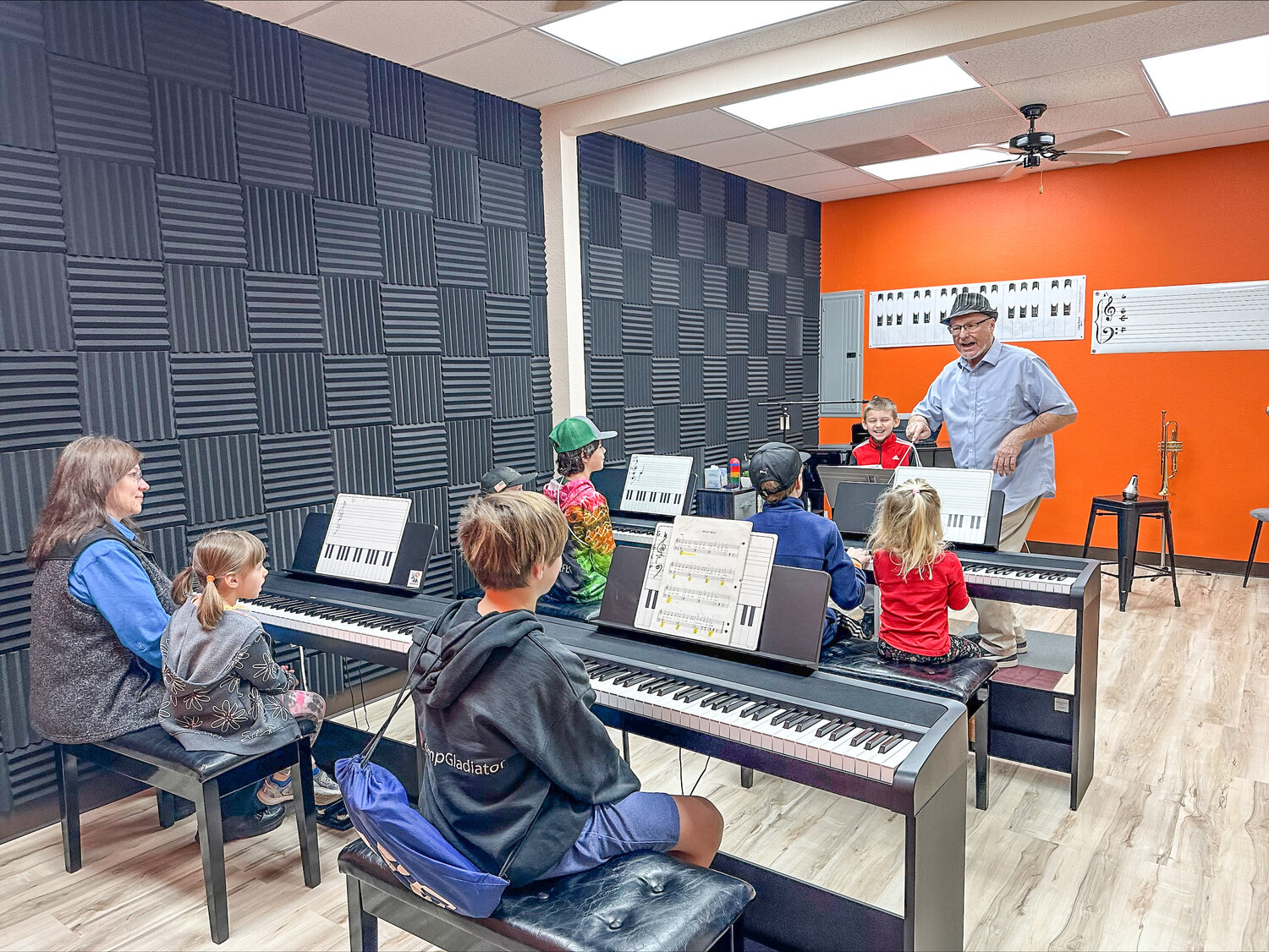 Michael Manning teaches piano to a group of young students at Sparks Music School.