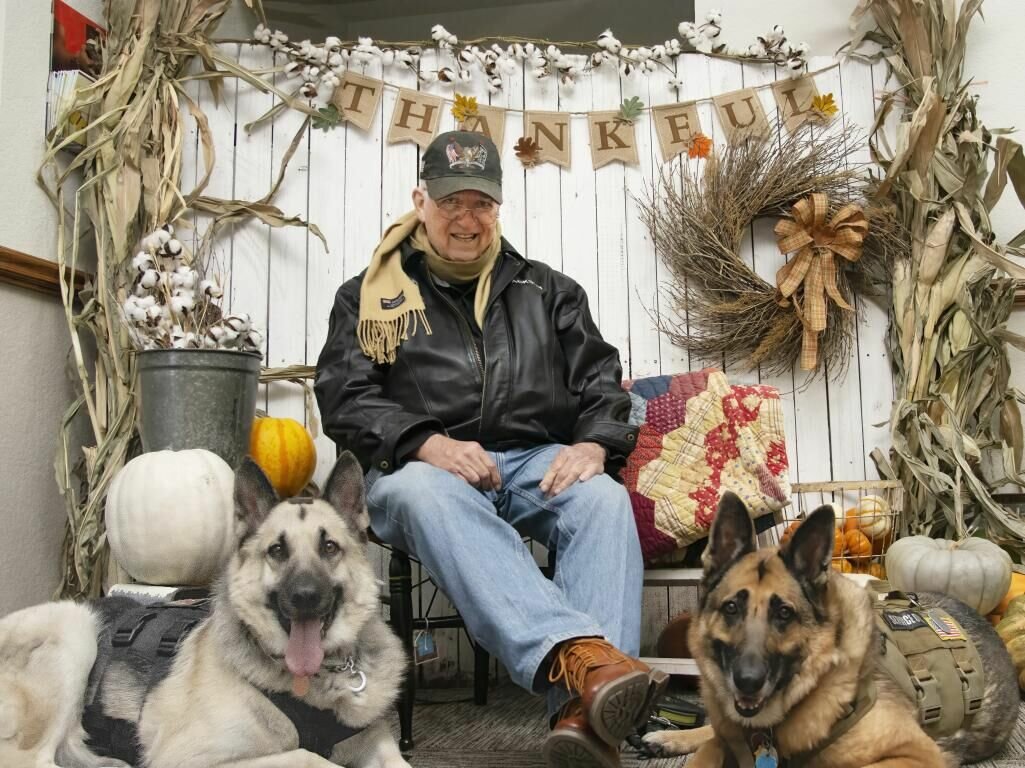HARD WORKERS: Jackson Fulgham is joined by his two service dogs, Striker (left) and Lacy (right). Fulgham breeds, trains and raises German shepherd puppies to give away to qualified veterans in need of a service dog.
