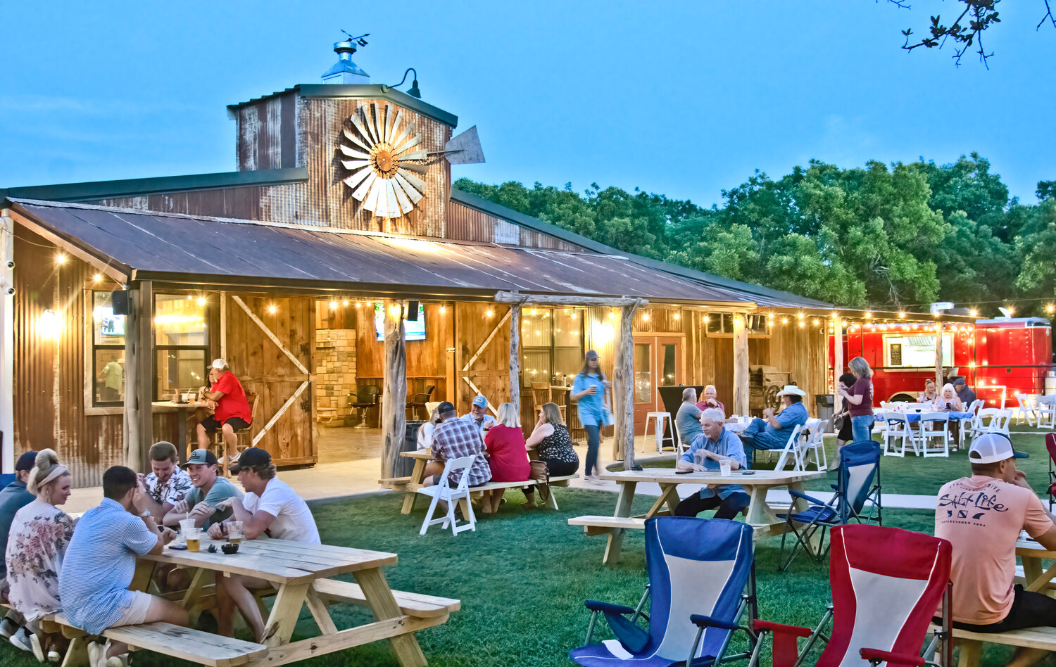 A PLACE TO RELAX: The new Warren's Backyard offers a bar, outdoor seating under lighted oak trees, food truck fare, games, and a stage for live band performances.