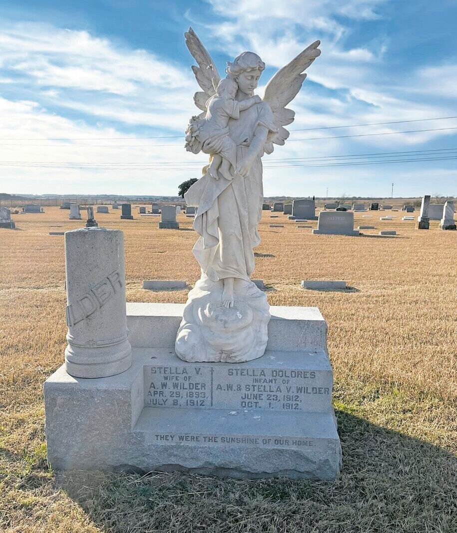 THE ANGEL: One of the most beautiful headstones in the cemetery is a statue of a large angel holding her baby, with the inscription, "They were the sunshine of our home," featured at the bottom of the statue. 