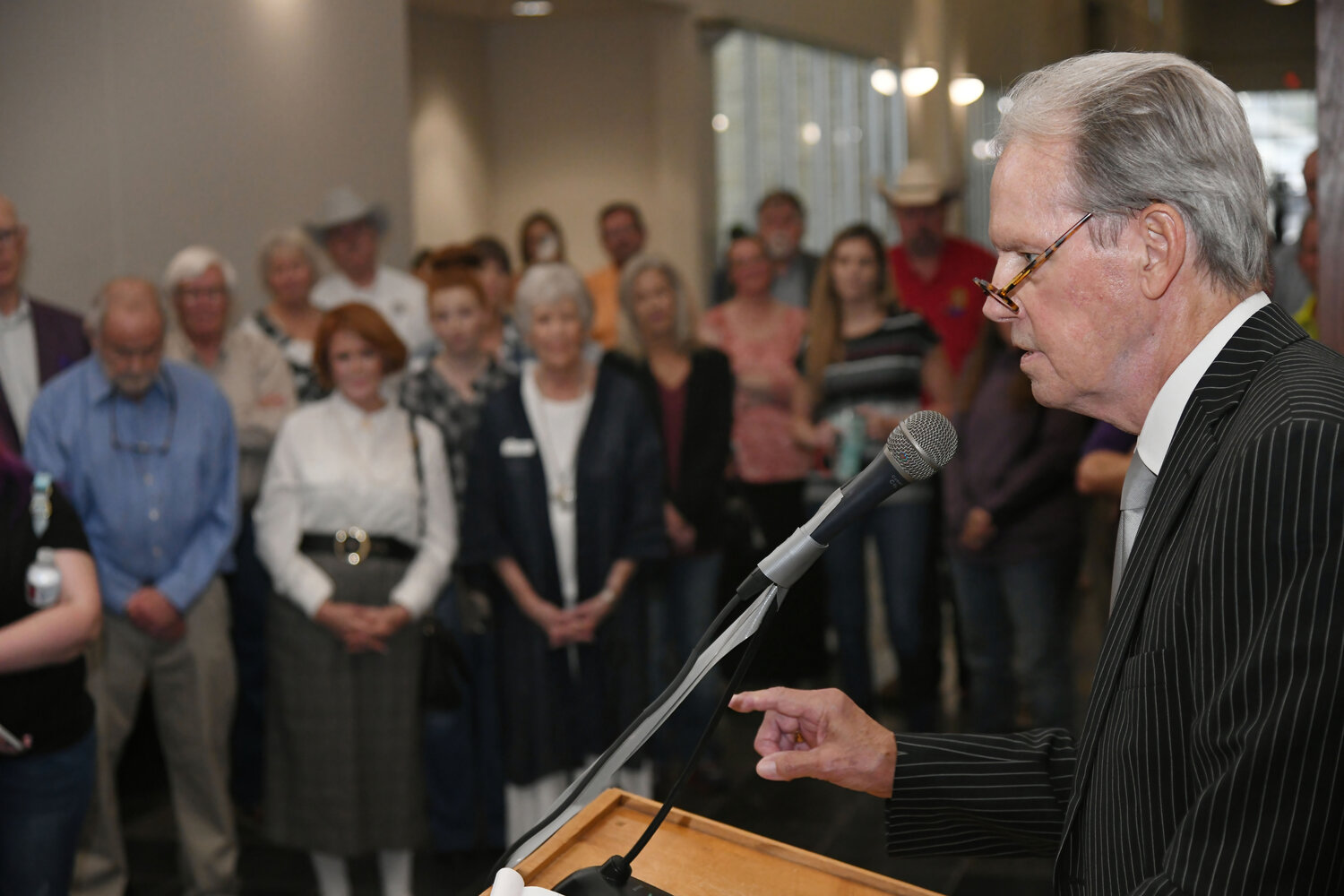 Former Hood County District Judge Ralph Walton speaks to the public during the unveiling ceremony of his portrait painted by local artist James Spurlock.