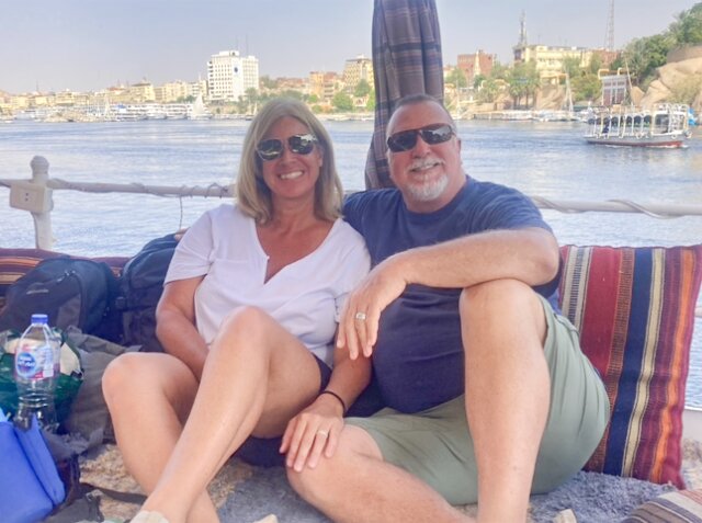 Susy and Jon Curtner are pictured sitting on the deck of a felucca boat in the Nile River in Aswan, Egypt.