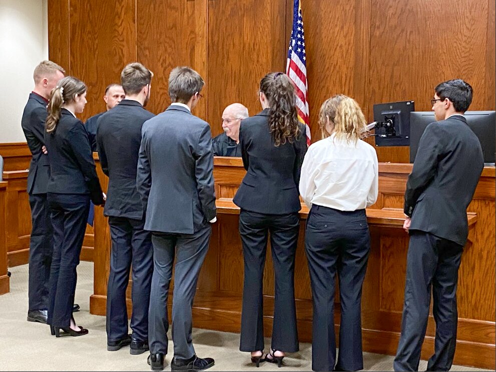 Granbury High School debate students talk with Hood County Justice of the Peace for Precinct #1 Roger Howell before a Hood County Teen Court last year.