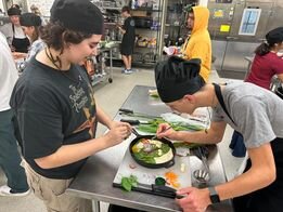 Practicum of Culinary Arts students paired with art students to apply art concepts to focaccia bread designs.