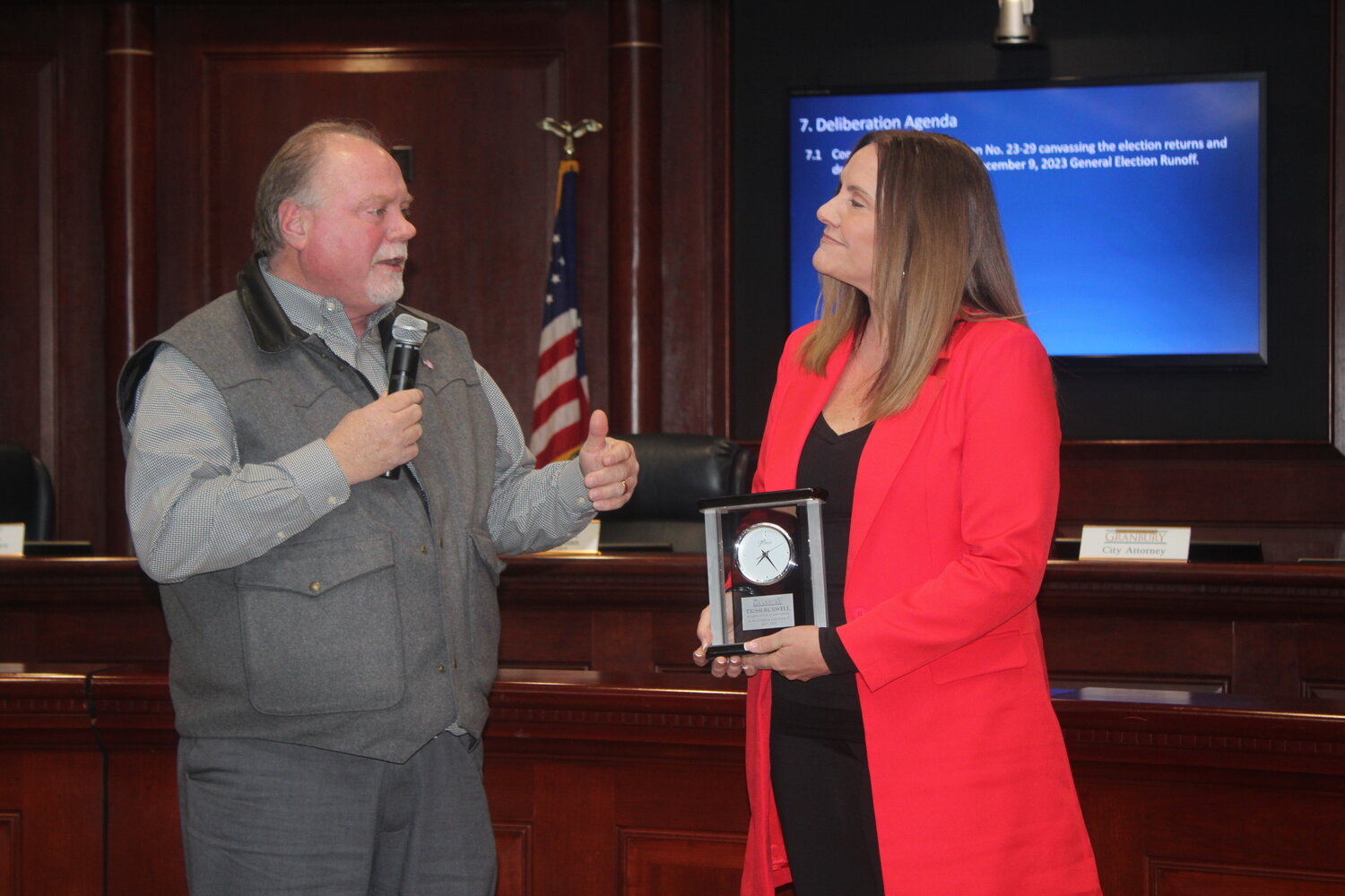 Mayor Pro Tem Trish Burwell receives a clock from City Manager Chris Coffman as she steps down as a city council member during a regular meeting of the Granbury City Council on Dec. 19.