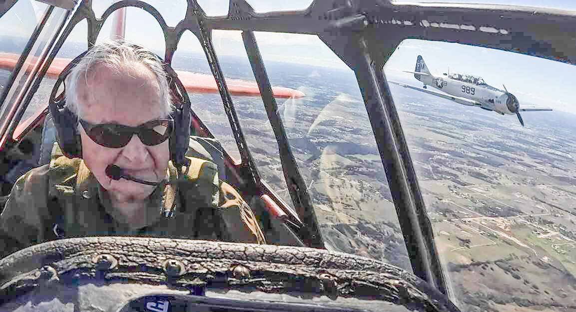 Retired World War II pilot Charles Baldwin takes to the skies again for a surprise birthday present on Saturday, Feb. 3, at the Vintage Flying Museum in Fort Worth. His son, Rick, is pictured flying in another plane to the right.