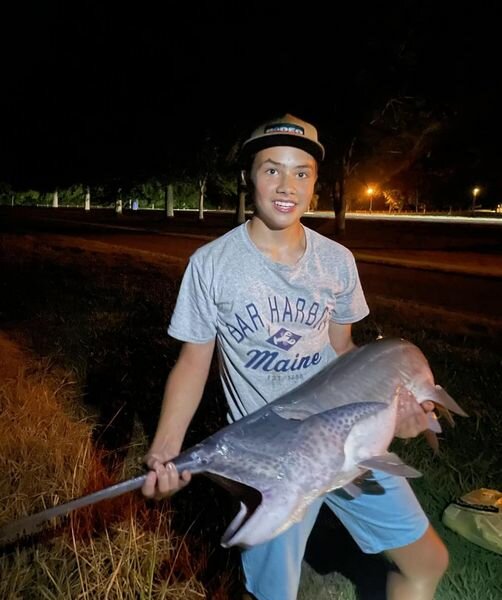 Elijah Conner, 13, of Cookeville holding his 40-plus pound paddlefish.