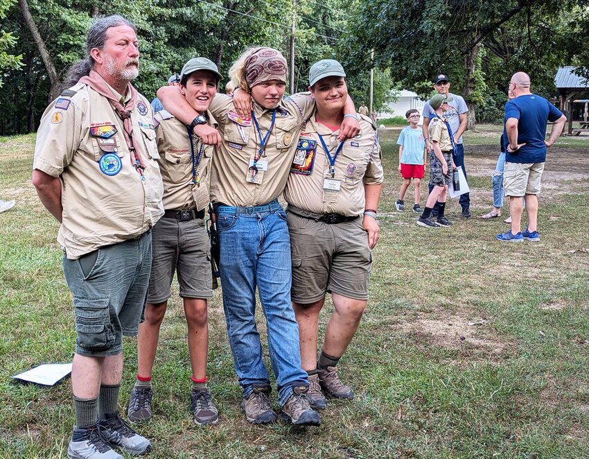 Troop 404 Scoutmaster Marc Bowen celebrates NYLT graduation with Conner Dawson, Drew Mayes, and Cormac Nolan (left to right). Dawson and Mayes completed the six day training in July 2024. Nolan served as an instructor in their class.