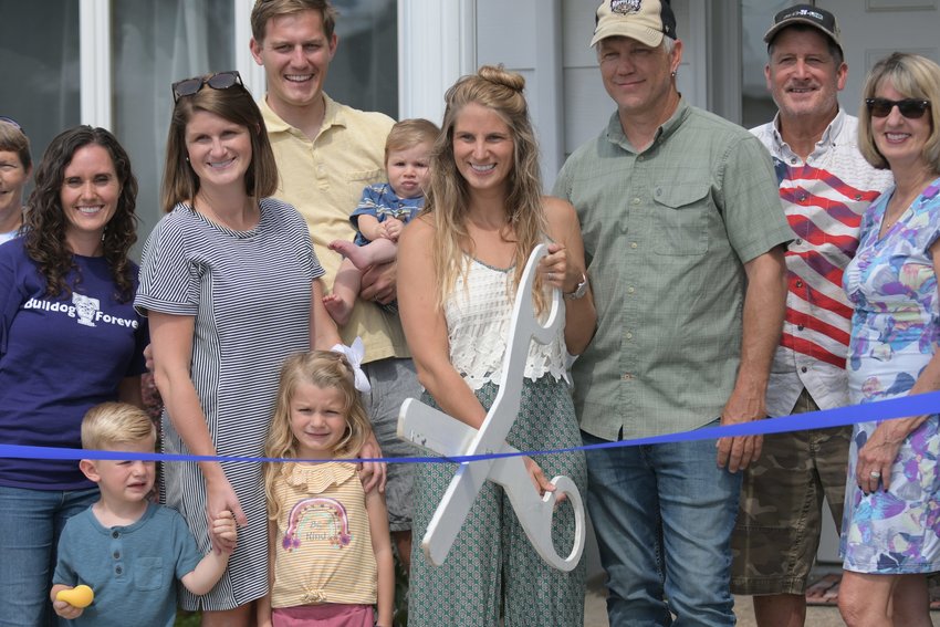 Amanda Montgomery participates in a ribbon-cutting ceremony Thursday, organized by the Kirksville Chamber of Commerce. Montgomery opened Mystic Meadows Yoga in April.