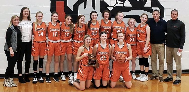 The Kirksville girls basketball team poses with its district title trophy.