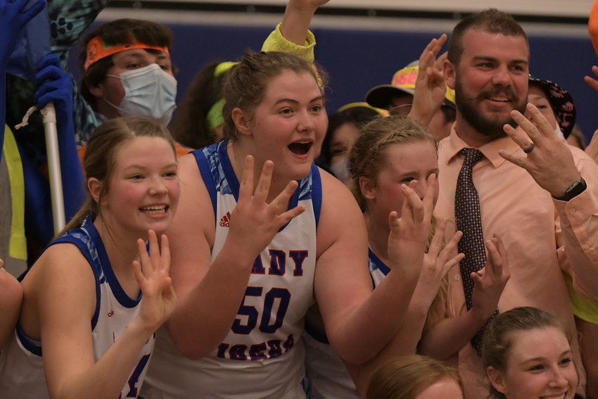 The Scotland County girls basketball team holds up four fingers to celebrate its quarterfinal win over Eugene on Saturday, which sends them to the Final Four. Pictured left to right: Abby Doster, Alaynna Whitaker, Hannah Feeney, coach Cory Shultz.