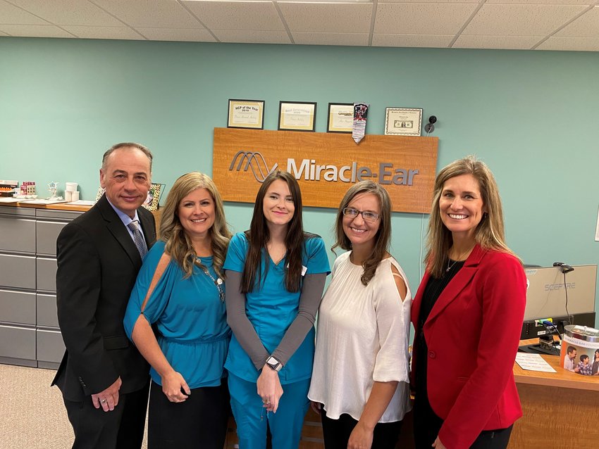 Kirksville Miracle-Ear staff members Tina Atchley (in white) and Alex Higgins (to her left) pose after receiving their Top Provider Team for 2020 award.