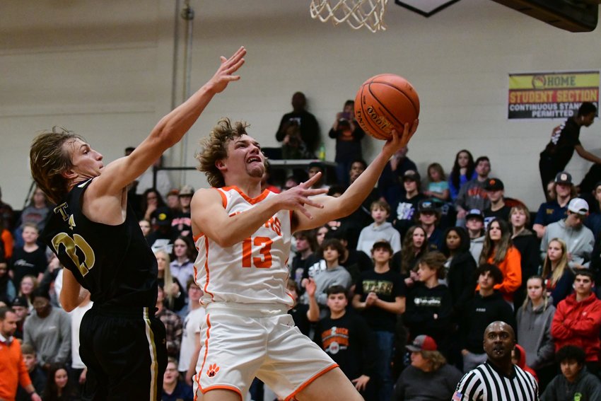Macon senior Preston Stewart goes up for a layup during the second half of the Tigers' win over Trenton to open the season.