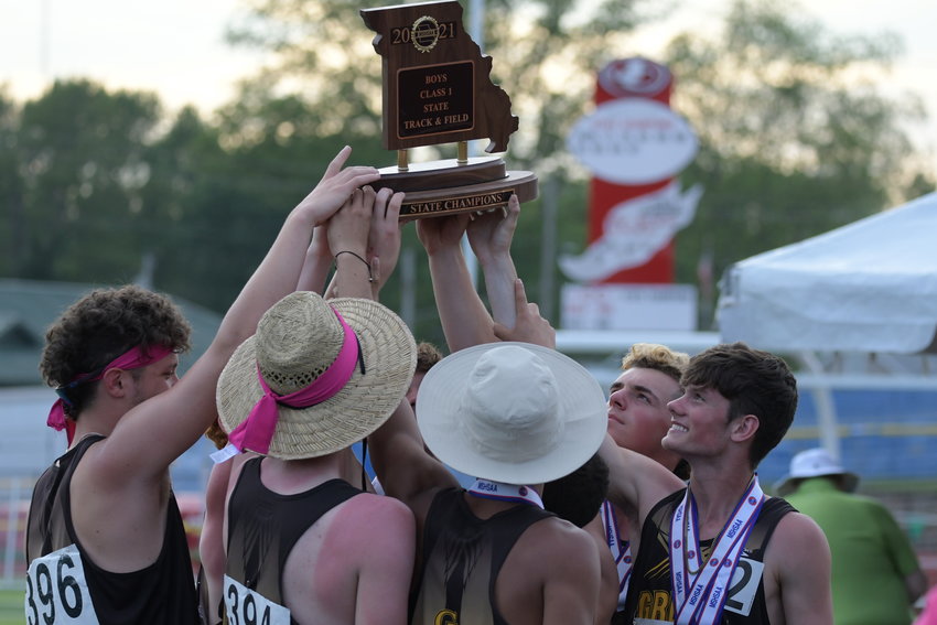 The Green City boys track team hoists its state title after claiming the Class 1 crown.