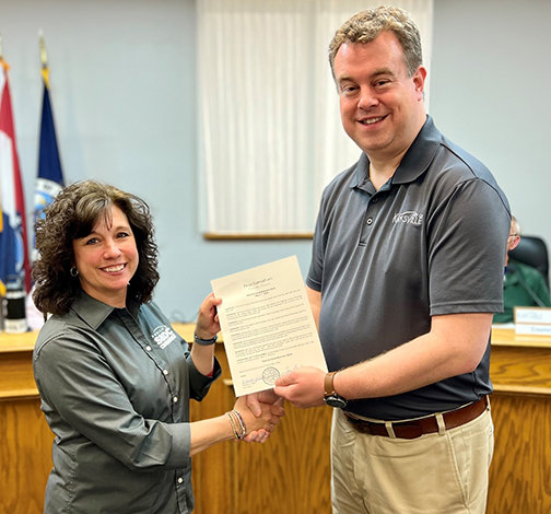 Anastasia Tiedemann, small business counselor for the Kirksville SBDC, receives a proclamation from Kirksville Mayor Zac Burden at the May 2 city council meeting.