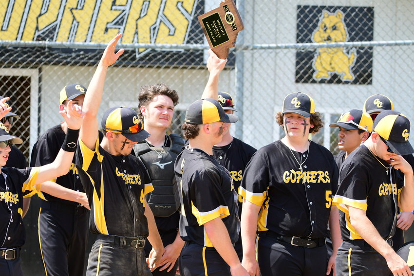 Green City's Laydon Fields hoists the team's district trophy following a 7-0 win over Novinger on May, 17, 2022.