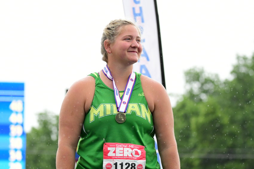 Milan's Cady Pauley reacts as she stands on the podium after winning the Class 2 girls shot put title on Saturday, May 21, 2022.