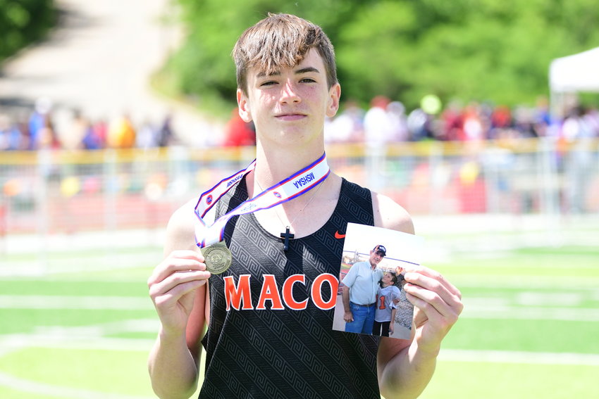 Macon's Caelan Harland poses with his gold medal and a photo of his grandpa, Murrell Arnett, after winning the Class 3 boys pole vault title on Friday, May 27, 2022.