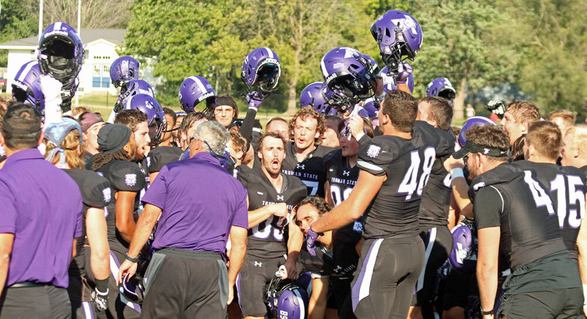 Truman players and staff celebrate in a postgame huddle after beating Tiffin 18-17 in overtime on Sept. 24 at Stokes Stadium.&nbsp;