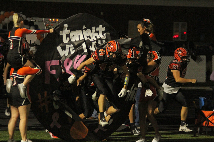 Macon players run through the banner prior to the game against Centralia on Oct. 21.&nbsp;