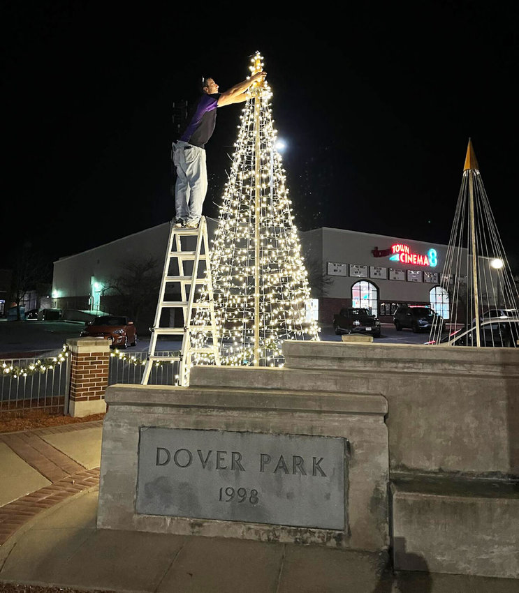 Christopher McLaughlin, a holiday lighting specialist with KV Winter Lights, works&nbsp; on the 15-foot-tall steel tree.