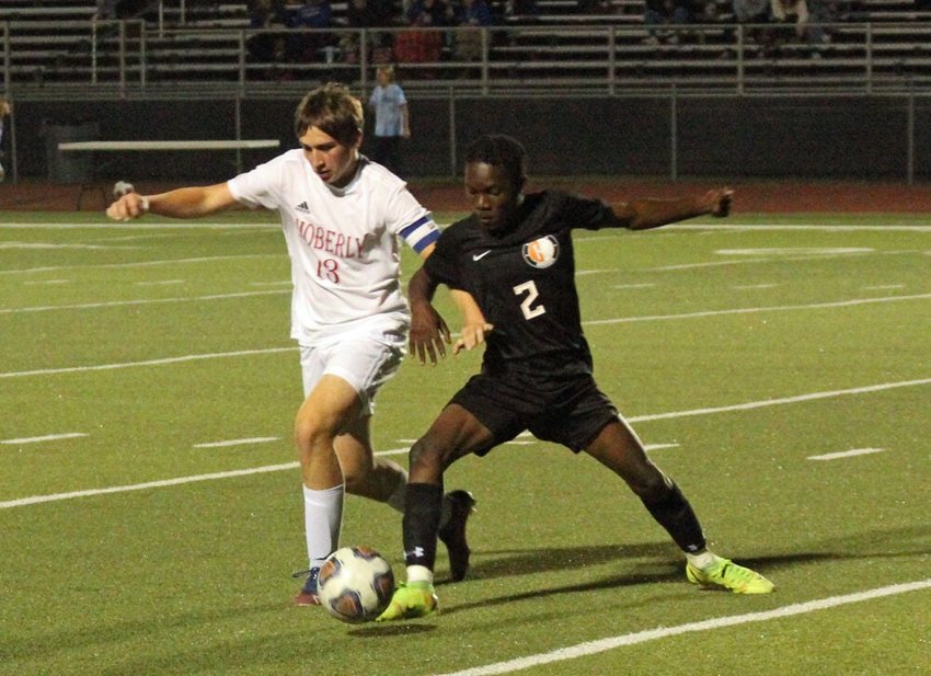 Kirksville junior Joel Mukatu fights a Moberly player for possession in the game on Oct. 6.&nbsp;