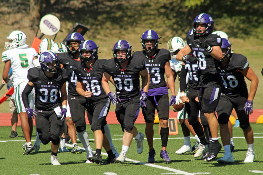 Members of Truman's kickoff coverage unit return to the sideline after the opening kickoff against Tiffin on Sept. 24.&nbsp;