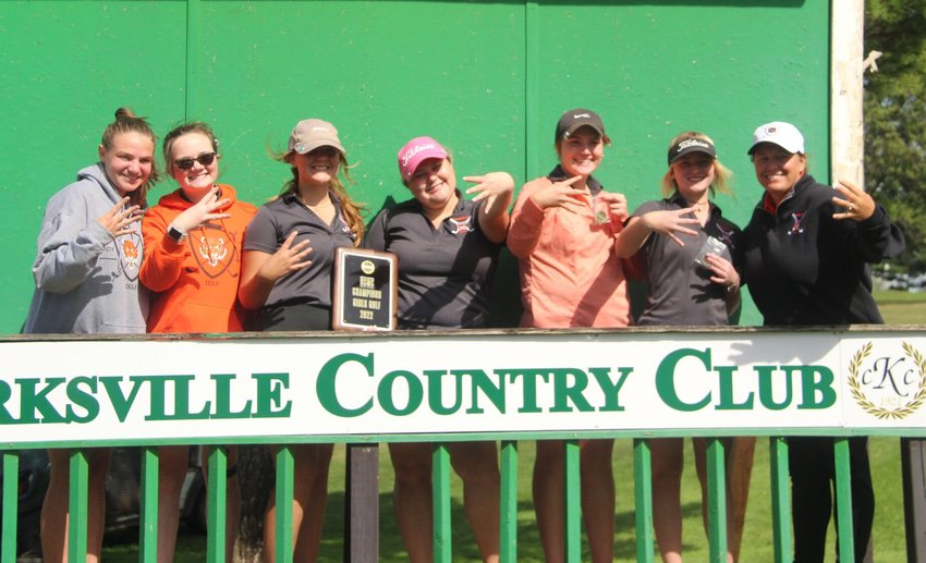 The Kirksville girls golf team and head coach Emily Powell hold up four fingers in celebration of their fourth-straight conference title on Monday at the Kirksville Country Club.&nbsp;