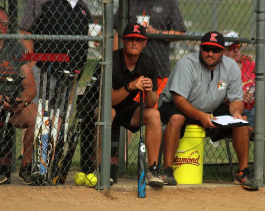 Kirksville softball coach Derek Allen (right) and assistant Tyler Martin watch on from the dugout during the Tigers' game against Chillicothe on Aug. 29.&nbsp;