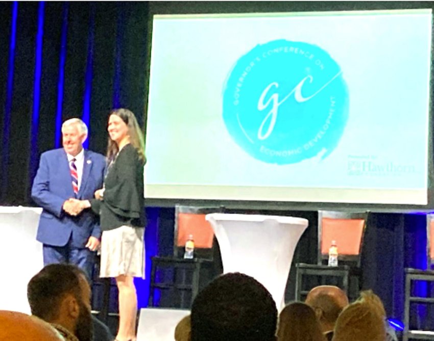 Pictured is Governor Mike Parson awarding Chrisman her pin.