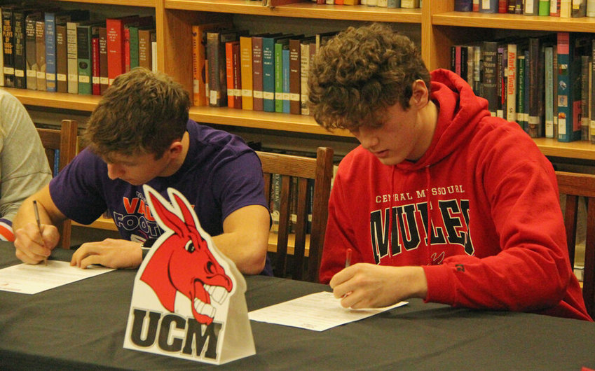 Jalen Kent (left) and Camden Dempsay sign their letters of intent to play college football in the Kirksville High School library on Feb. 1.&nbsp;
