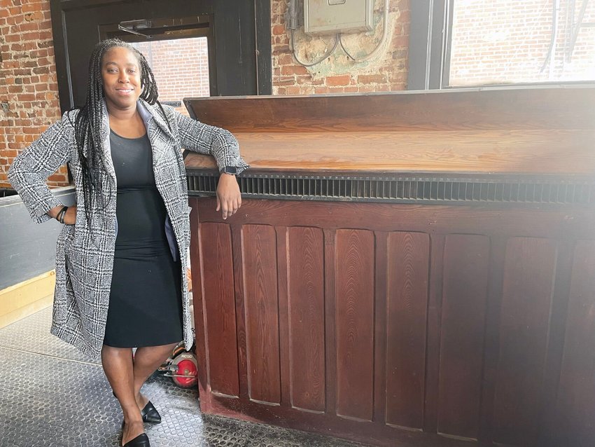 Stephanie McGrew, the managing partner of a business consortium that has purchased the Journal Print Co. building on South Elson Street and is working to open a new restaurant/nightclub in the building. McGrew is leaning on one of the Journal Print Co. presses.&nbsp;