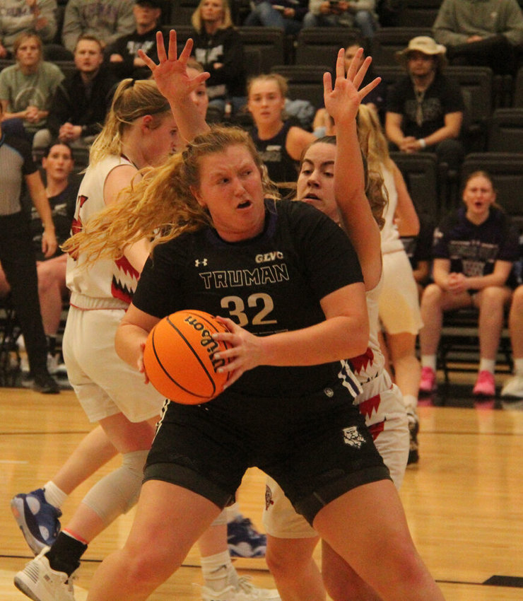 Truman forward Ellie Weltha fights her way toward the basket against Lewis on March 4.&nbsp;